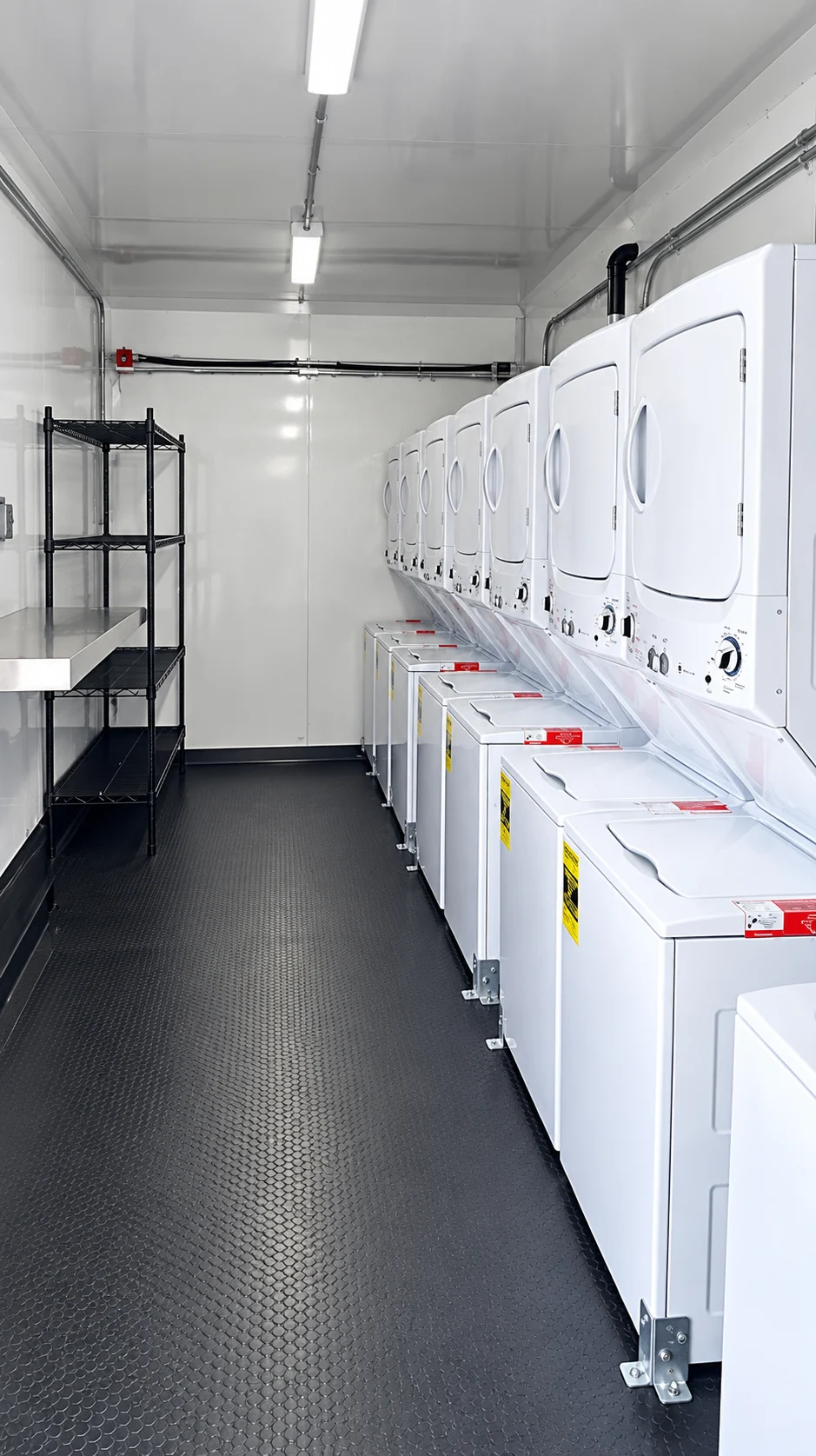 Laundry trailer interior reference with washing machines, dryers and a central aisle